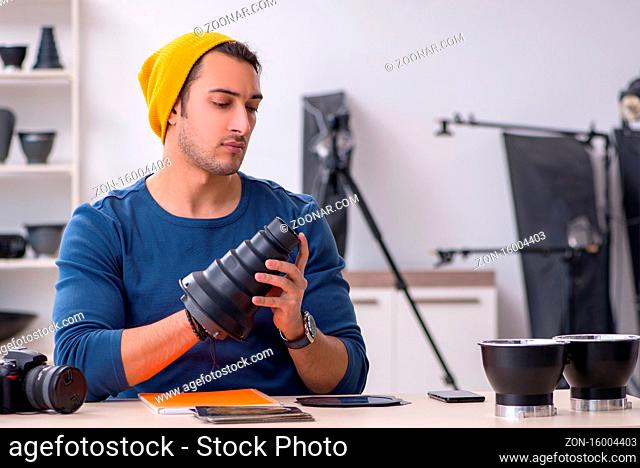 Young photographer working in the studio