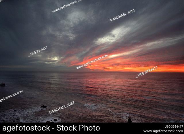 The sun sets along Californiaâ. . s Pacific Ocean Coastline