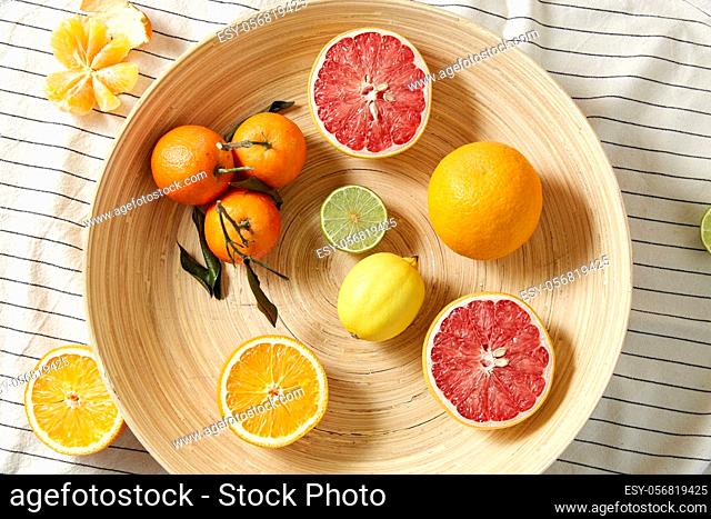 close up of citrus fruits on wooden plate