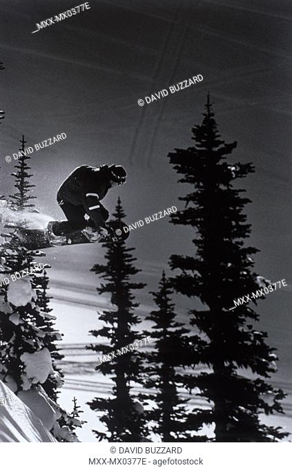 Snowboarder getting air through the trees, Whistler Back-country - B&W