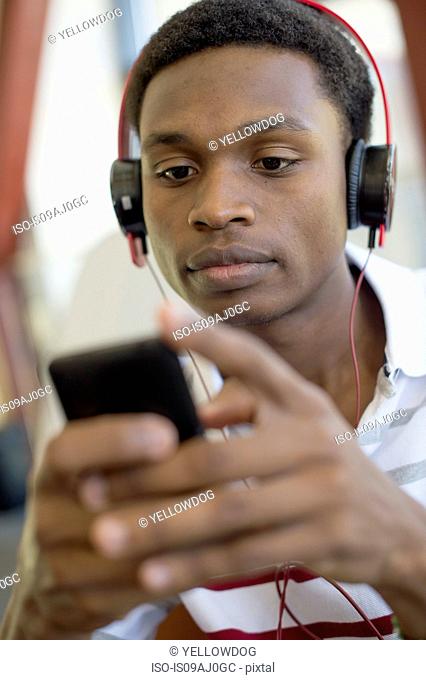 Young man using mp3 player