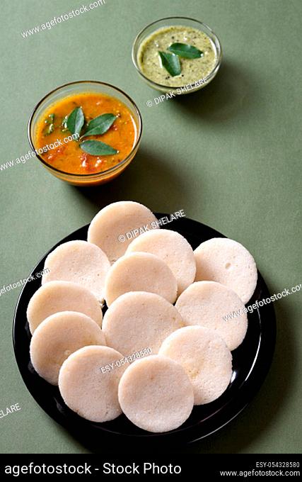 Idli with Sambar and coconut chutney, Indian Dish : south Indian favourite food rava idli or semolina idly or rava idly, served with sambar and green chutney