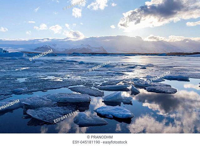 Breaking Ice over Jokulsarlon glacial lake winter season natural landscape background, Iceland