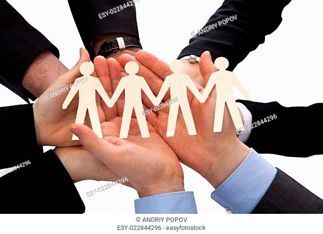 Businesspeople Holding Human Figure Cutout