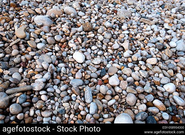 Beautiful and colourful sea pebbles on the beach creating a beautiful nature background
