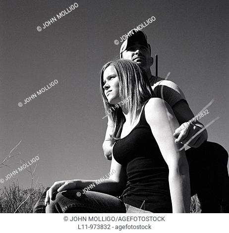 Man and woman with rifle; rural