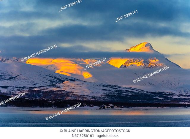 Winter landscape along the coastline near Tromso, Arctic, Northern Norway at sunrise