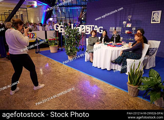 14 December 2023, Berlin: Guests have their photo taken at a laid table with a Hanukkah chandelier at the Jewish Community Day 2023 at the Intercontinental...