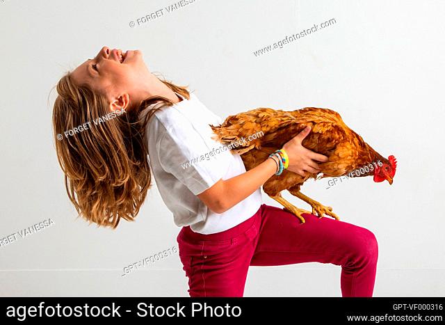 A GIRL AND HER HEN, CHILD AND PET, STUDIO PORTRAIT