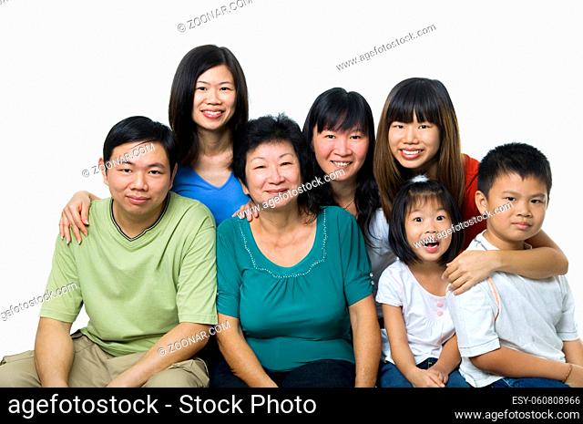 Larger Asian family portrait on white background, three generations