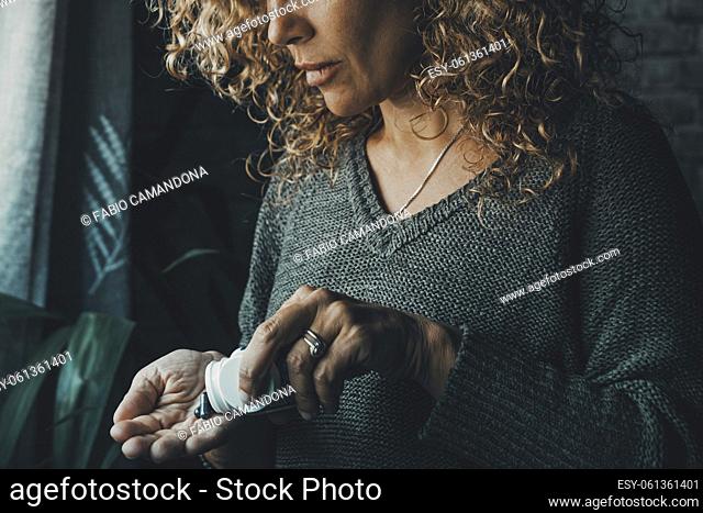 Close up of woman taking pills alone at home. Vitamins and diet medicine. Symptoms of influenza flu health. Female people take pharmacy pill on the hand