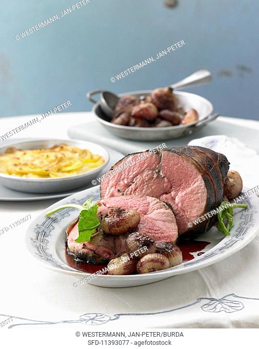 Sauerbraten (marinated pot roast) from milk-fed lamb with caramelised onions and potato gratin