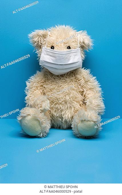Teddy bear wearing flu mask