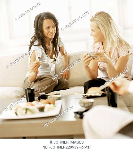 Two women eating sushi