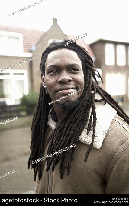 content African man walking in residential district in Leeuwarden, Friesland, Netherlands, Europe