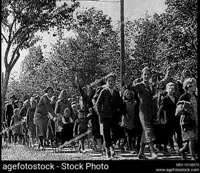 Sudeten Germans Walking Along a Path Lined With Tree As If Refugees Away From Czechoslovakia, Some Making The Nazi German Salute - Czechoslovakia