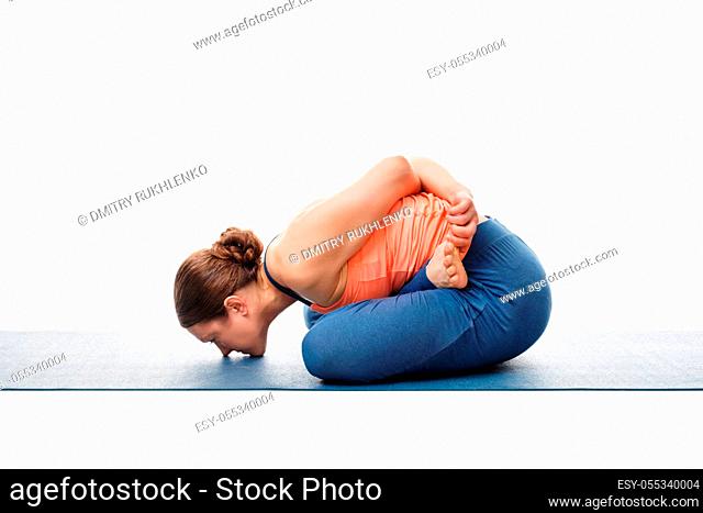 Woman doing Asthanga Vinyasa Yoga asana Yoga mudrasana (yoga mudra) - psychic union pose isolated on white background