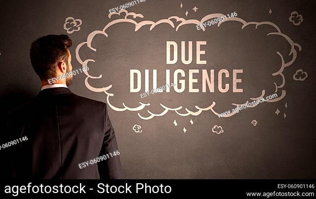 businessman drawing a cloud with DUE DILIGENCE inscription inside, modern business concept