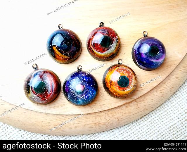 Create galaxy drink coasters using resin, glitter and pigment powders, handmade items. Suitable for keychains, necklace and pendant