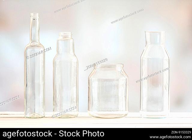 Glass bottles on a row on a wooden table
