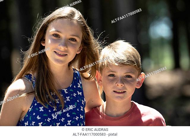 Close-up of brother and sister standing outdoors