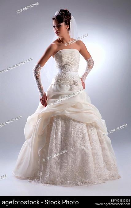Young beautiful dark-haired woman in a wedding fashionable dress