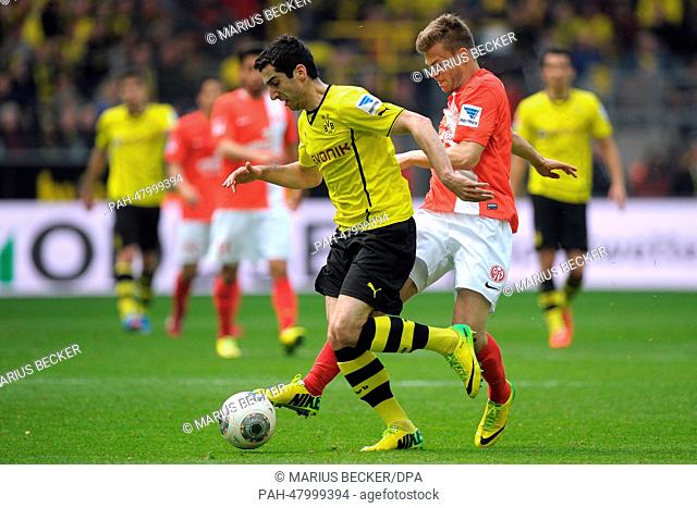 Dortmund's Henrikh Mkhitaryan (L) vies for the ball with Mainz's Benedikt Saller during the Bundesliga soccer match between Borussia Dortmund and 1