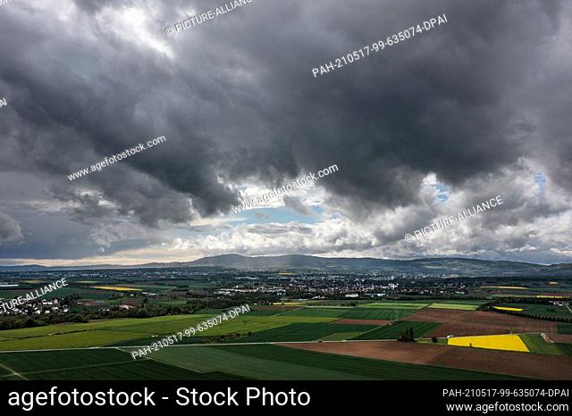 17 May 2021, Hessen, Nieder-Erlenbach: Dark storm and thunder clouds pass over the Feldberg and the Taunus (aerial view with a drone) Photo: Boris Roessler/dpa