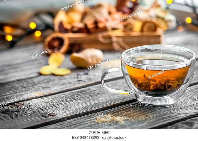 still life with transparent and fragrant Cup of tea with ginger on wooden background