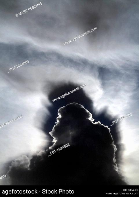 Dramatic storm clouds in sunny sky