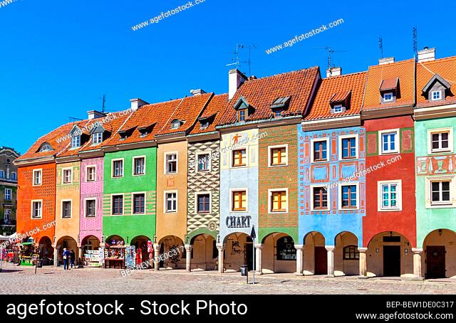 Poznan, Poland - June 5, 2015: Historic merchant tenement houses - domki budnicze - and City Hall at Rynek Old Market Square in Old Town city center