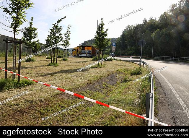 15 June 2021, Thuringia, Eisenberg: Barrier tape is stretched around a hazardous goods truck in a parking lot on Highway 9