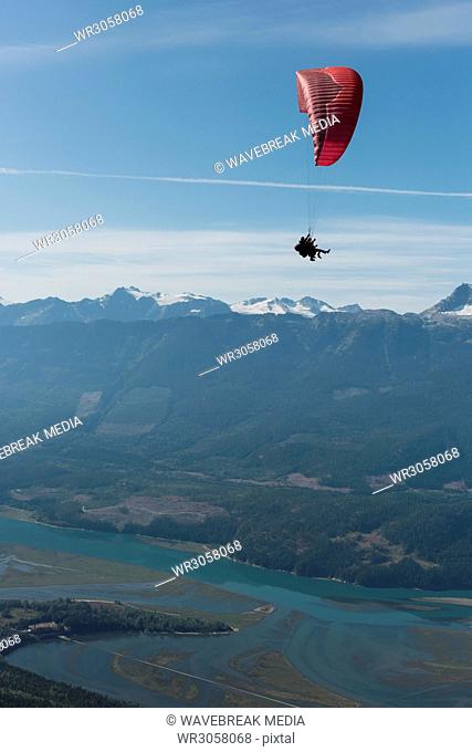 Paraglider flying over beautiful mountain