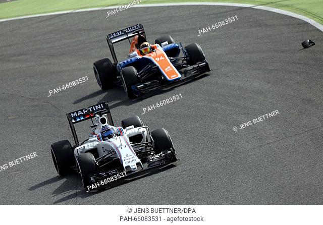 Finnish Formula One driver Valtteri Bottas of Williams steers the new car FW38 in front of German Formula One driver Pascal Wehrlein of Manor Racing during a...