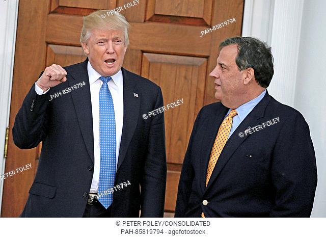 United States President-elect Donald Trump (L) gestures with New Jersey Governor Chris Christie at the clubhouse of Trump International Golf Club