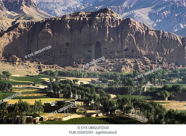 View of Bamiyan valley and village showing cliffs with empty niche where the famous carved Budda once stood (destroyed by the Taliban in 2001)