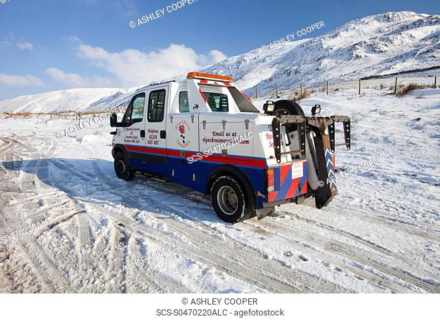 A break down recovery vehicle on Kirkstone Pass in the Lake District in Winter snow