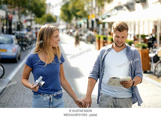 Netherlands, Maastricht, happy young couple exploring the city