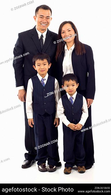 Full length of happy Asian family of four standing isolated over white background