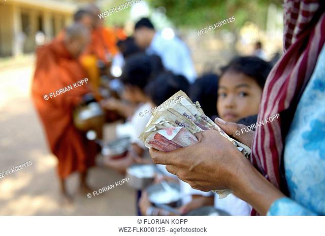 Cambodia, Takeo Province, Lompong, Cildren donating to Buddhistic monks during New Year's festival