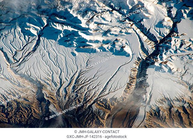 The Himalaya range, near the China-India border.. where peaks cast strong evening shadows on the snow. For millions of years