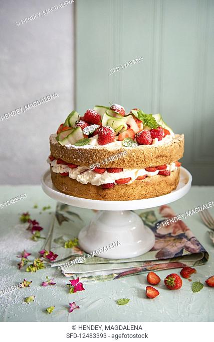 Summer cake, genoise sponge with strawberries soaked in Pimms with mint and lemon, cucumber ribbons and creamy mascarpone filling