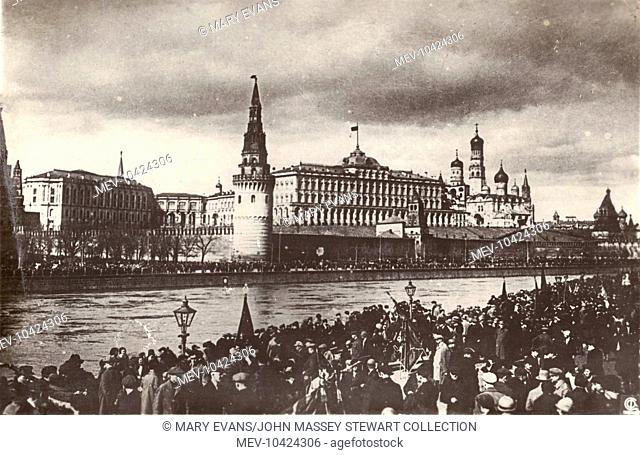 View of the Kremlin in Moscow from across the River Moskva on May Day, 1 May 1928. Large crowds are gathered on both sides of the river