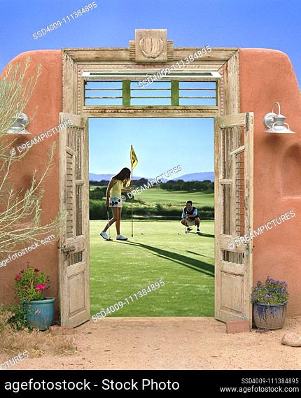View through doorway to couple playing golf
