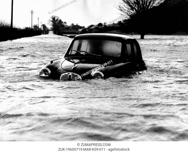 July 19, 1960 - Shrewsbury, Shropshire, U.K. - A car abandoned in the flood waters of the overflowing River Severn, near Poolquay in 1960