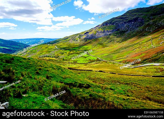 The Struggle road at Kirkstone Pass leading to Windermere lake Ambleside with Snarker Pike of Red Screes mountain on right in Lake District England
