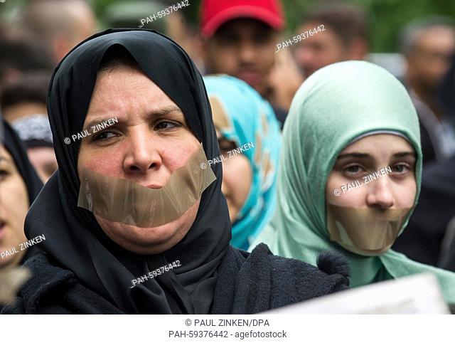 Two women with tape over their mouths outside a police station, Berlin, Germany 21 June 2015. A protest of about 60 people calling for the release of Al Jazeera...