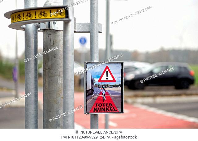 23 November 2018, Lower Saxony, Garbsen: The new ""Bike-Flash"" warning system hangs on a mast in an industrial park at a crossroads