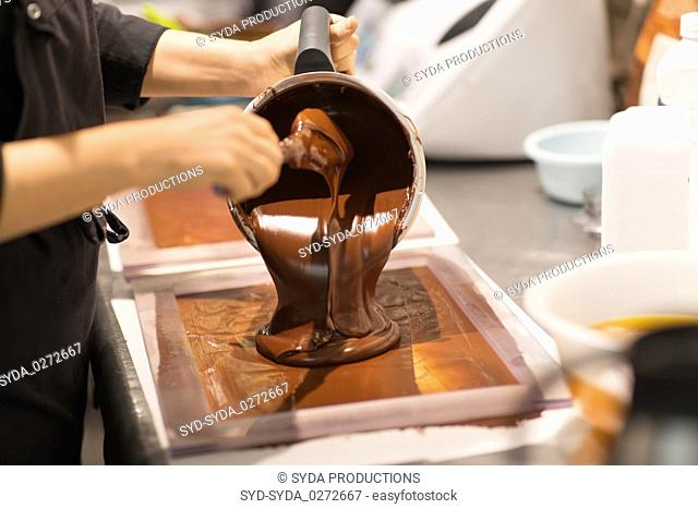 confectioner makes chocolate dessert at sweet-shop