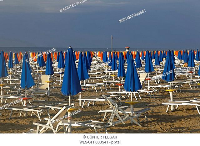Italy, Friuli-Venezia Giulia, Province of Udine, Lignano Sabbiadoro, Beach with sun loungers in the evening
